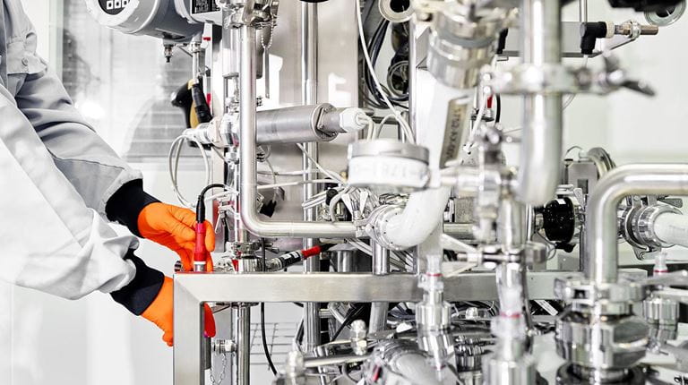 Bern manufacturing employee adjusting settings tank