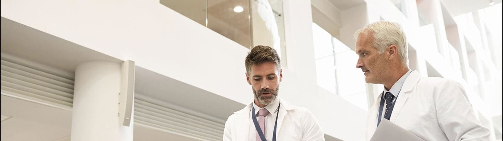 Two scientists walking in a corridor